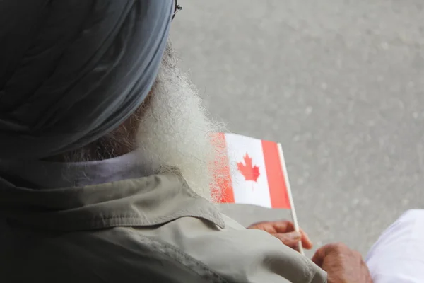 stock image Sikh Indo-Canadian holds Canadian Flag