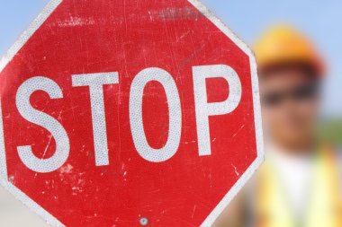 Flag Person Holds Stop Sign clipart