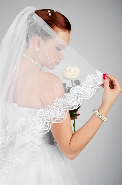 Portrait of young beautiful bride with rose — Stock Photo, Image