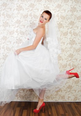 Portrait of young beautiful bride in shoes