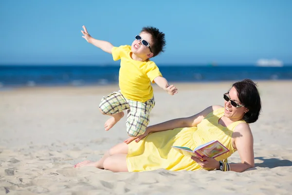 Ung mor och son att ha kul på stranden — Stockfoto