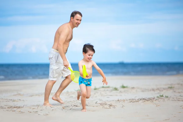 Father and son having fun on the beach Stock Photo