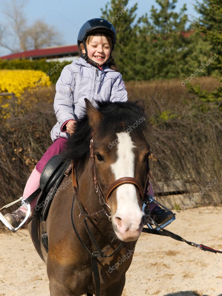 Preschool girl ride on pony — Stock Photo © scigelova #11437875