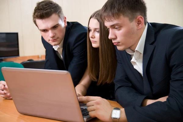 Tre unga affärsmän med laptop — Stockfoto