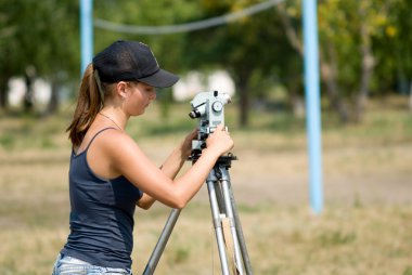 The student learns to work with a theodolite clipart