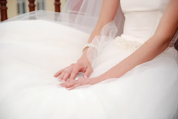 Руки на свадебное белое платье — стоковое фото