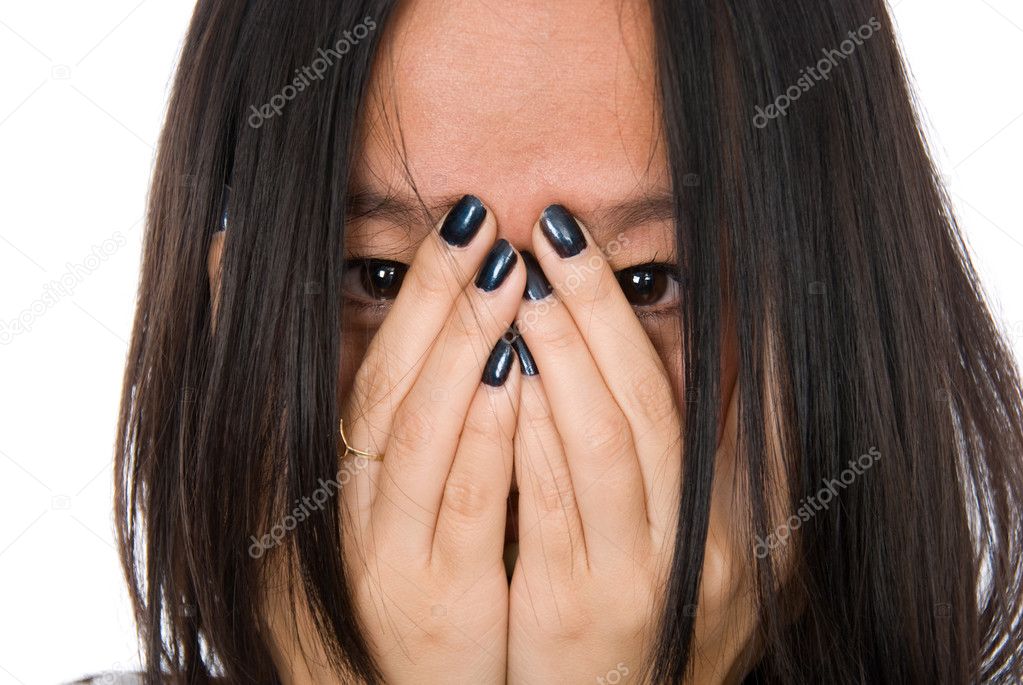 Close-up portrait girl in despair shuts face with hands