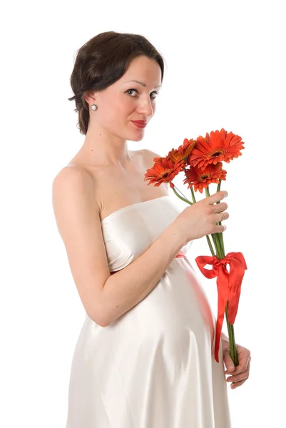 Pregnant woman with a bunch of flowers — Stock Photo, Image