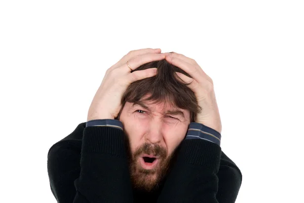 Shocked man with a beard holds hands head — Stock Photo, Image