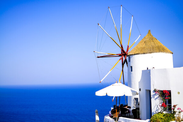 Traditional white windmill in Oia, Santorini island, Greece