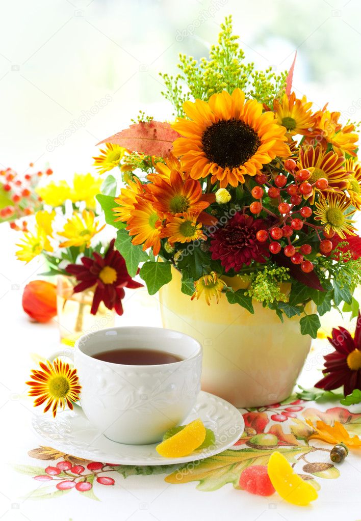 Cup of tea and autumnal flowers