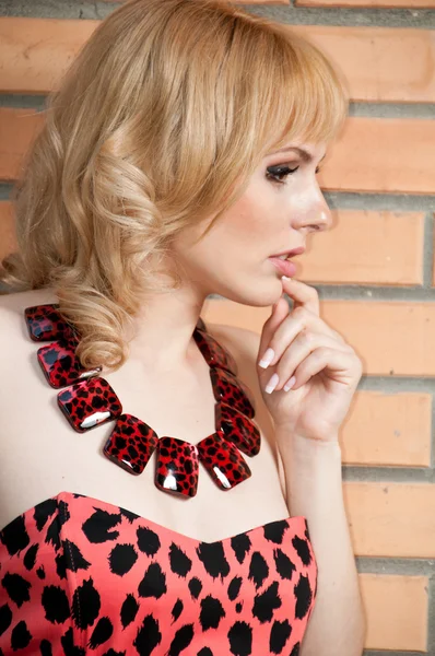 A large portrait of a beautiful blonde girl in a leopard dress — Stock Photo, Image