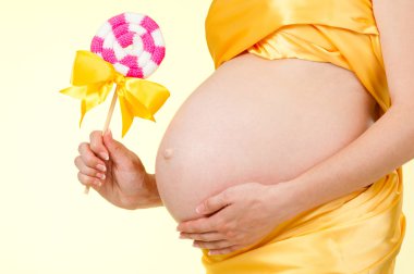 Pregnancy. Close-up of a pregnant woman's tummy. clipart