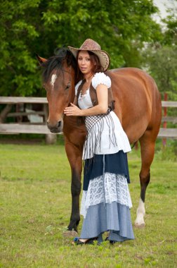 A beautiful girl in a cowboy hat with a horse clipart
