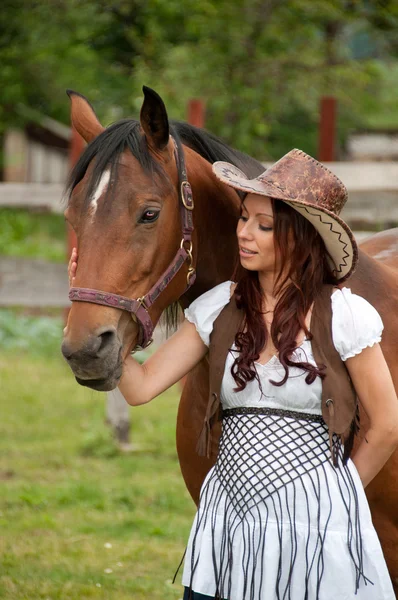 Kovboy şapkalı bir atı ile güzel bir kız — Stok fotoğraf