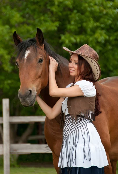 Ένα όμορφο κορίτσι σε ένα καπέλο με ένα άλογο — Φωτογραφία Αρχείου