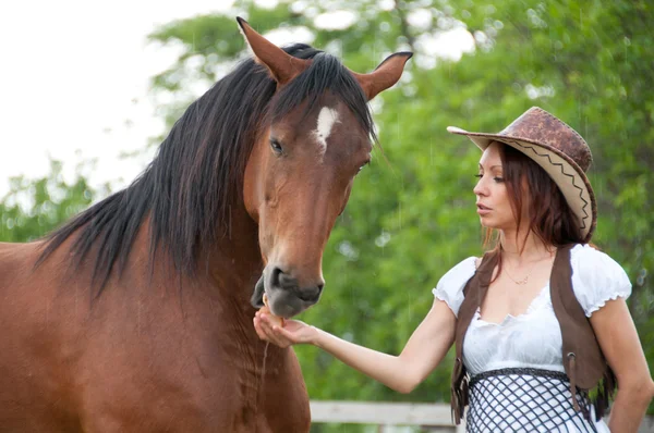 Beautiful girl feeding a horse — Stok fotoğraf