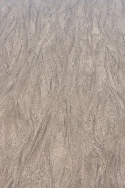 Areia após o pincel ondas — Fotografia de Stock