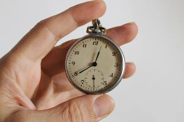 Old pocket watch clock on human hand — Stock Photo, Image