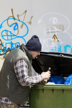 Tramp digging in dumpster clipart