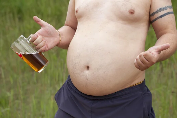 Fat man with a beer in hand — Stock Photo, Image