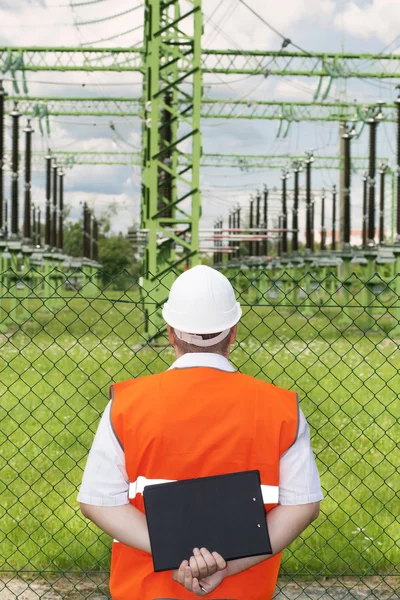 Engineer near the electricity substation — Stock Photo, Image