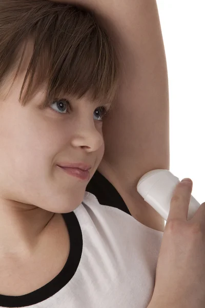 Girl applying deodorant on armpit — Stockfoto
