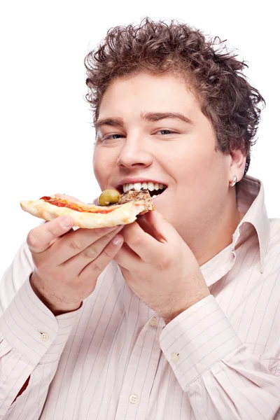 Щасливий пухкий хлопчик їсть шматочок піци — стокове фото