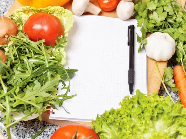 Note book among the vegetables — Stock Photo, Image