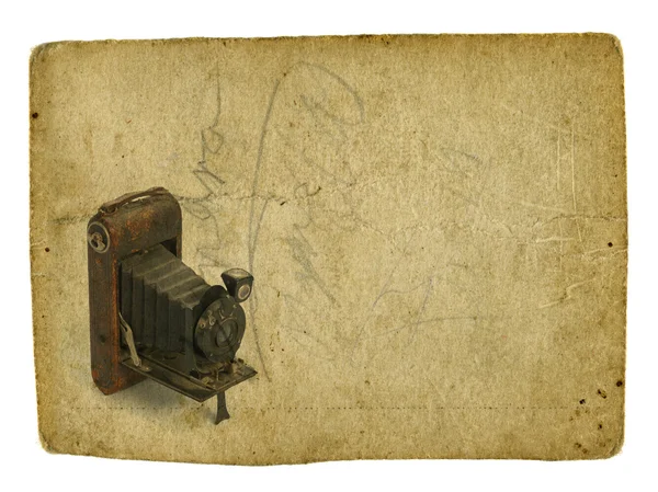 Старая фотокамера на винтажном фоне — стоковое фото