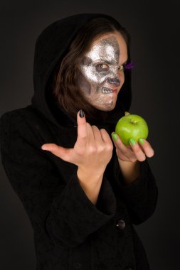 Two-faced sorceress with green apple tempts clipart