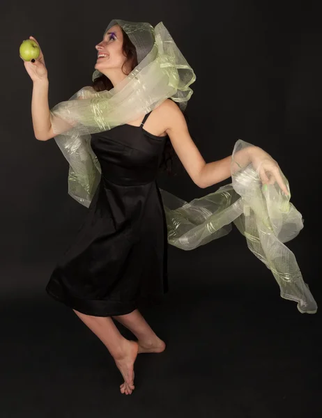Two-faced woman with green apple dancing — Stock Photo, Image