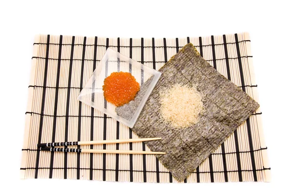 Making Sushi on a bamboo sushi mat — Stock Photo, Image