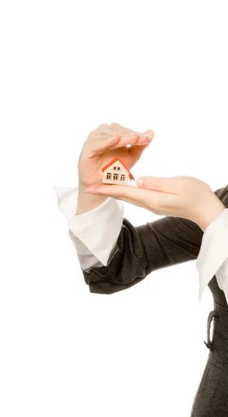 Girl covering toy house with hand — Stock Photo, Image