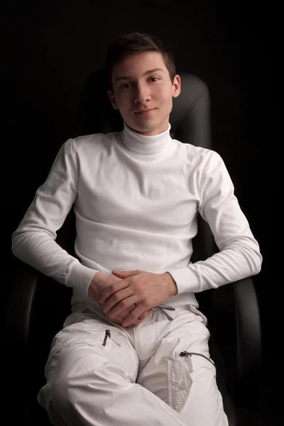 Man in white sitting in armchair — Stock Photo, Image