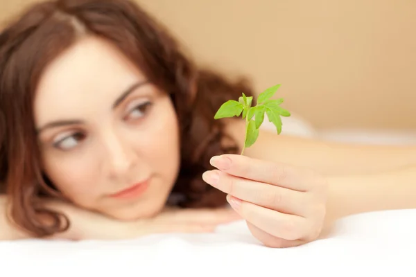 Woman holding a plant (focus on sprout) — Stock Photo, Image