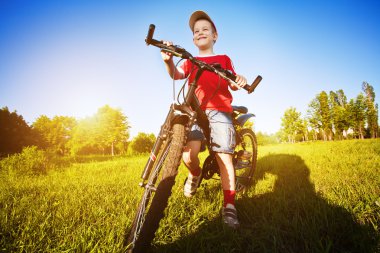 Six year old boy on a bike clipart