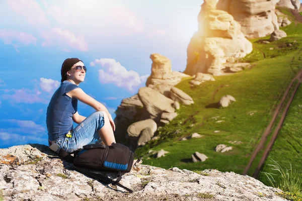 Girl is resting sitting on the grass in mountains — Stock Photo, Image