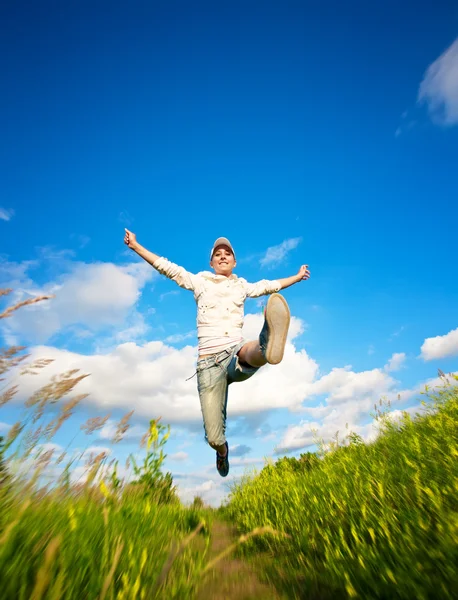 Fanny woman jumping over the blue sky — Stock Photo, Image