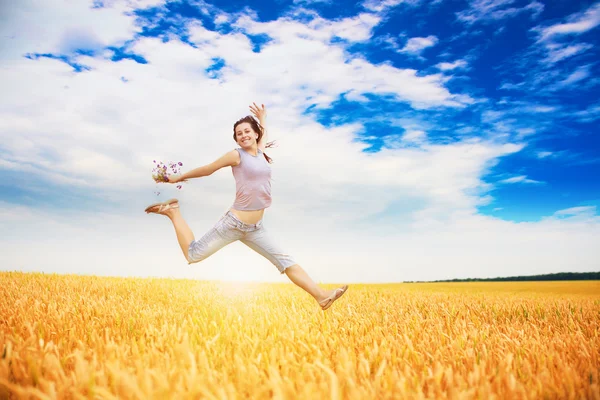 Dziewczynka skacze w dziedzinie — Zdjęcie stockowe