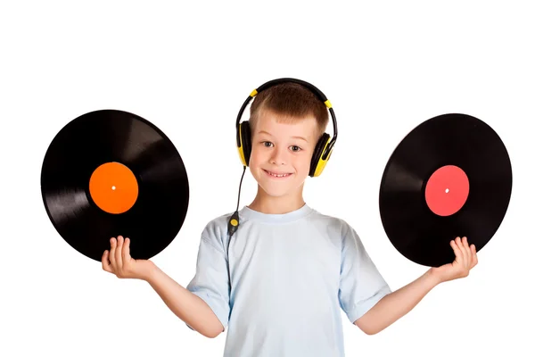 Niño pequeño con auriculares y discos —  Fotos de Stock