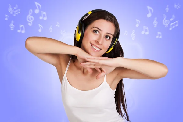 Chica atractiva está escuchando música con auriculares —  Fotos de Stock
