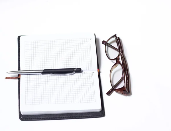 Notitieboekje met pen en bril — Stockfoto