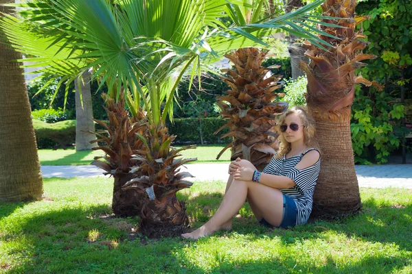 stock image Girl under a palm tree