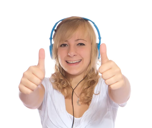 Mladá dívka poslouchá hudbu se sluchátky izolovaných na bílém ba — Stock fotografie