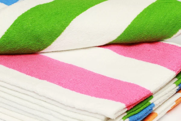 Colour terry towels combined by pile on white background. Isolated. — Stock Photo, Image