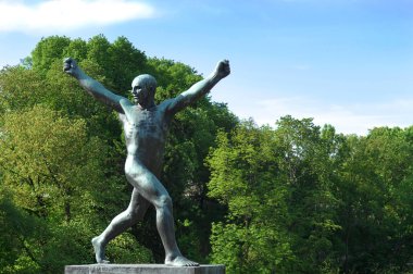 Sculpture of a man with his hands up clipart