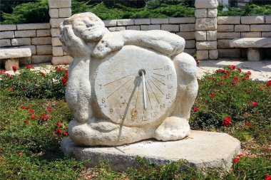 Sundial sculpture in the Rose garden clipart