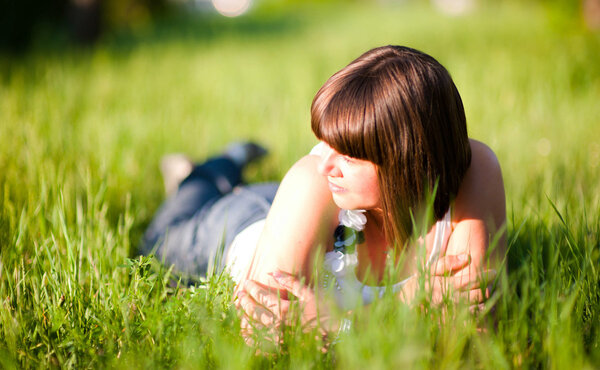 Pensive girl on grass