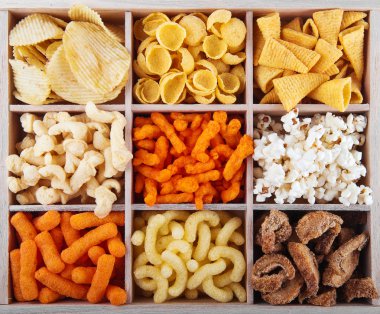 Variety of crunchy snacks in a box clipart